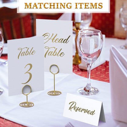 Foil head table signs and “Reserved” place card with gold table number stands