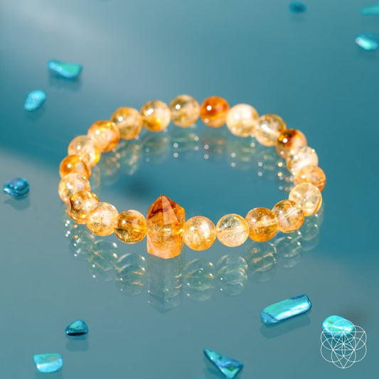 Citrine beaded bracelet with faceted amber tones and a central crystal charm