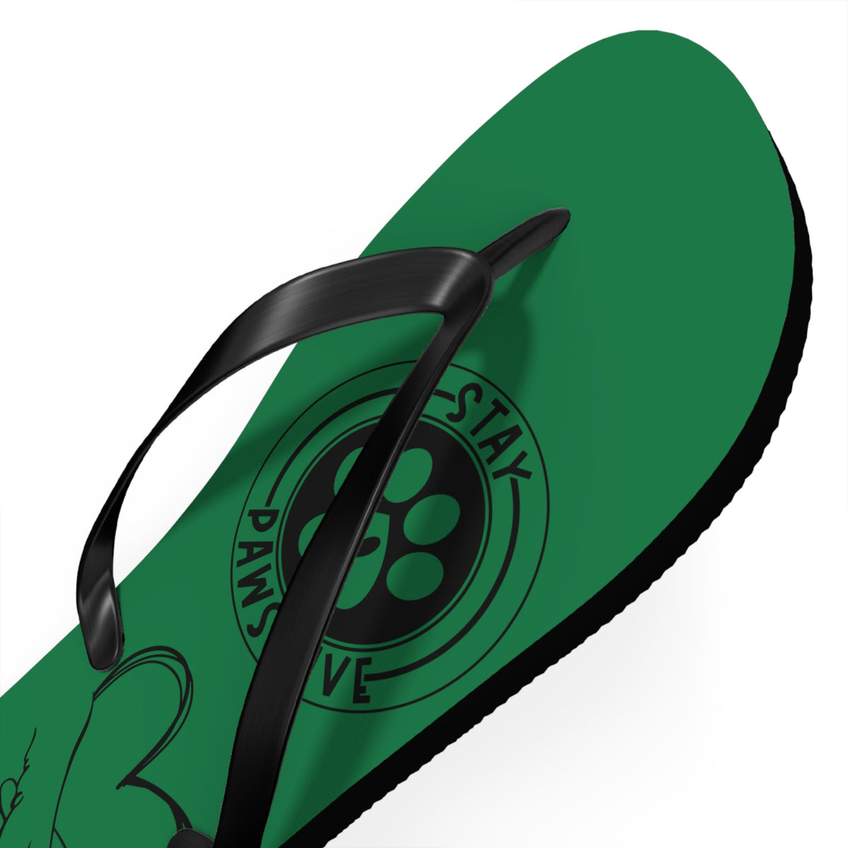 Green flip-flop close-up showing paw-print graphic on the inner strap