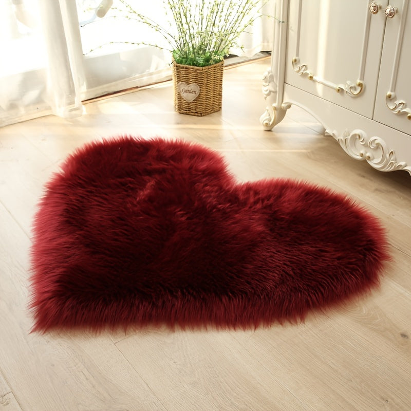 Heart-shaped faux fur rug with long shag pile, dark red plush carpet mat.