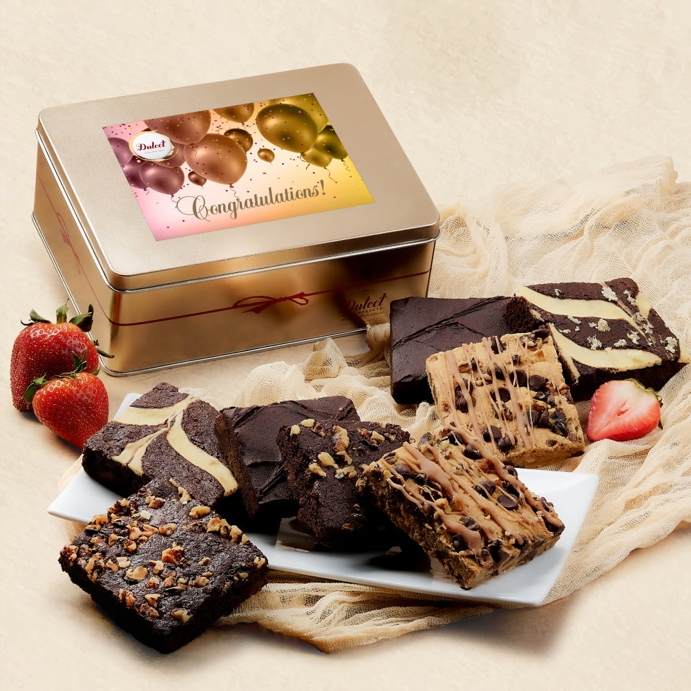 Gold gift tin with brownies and a Congratulations greeting card topper