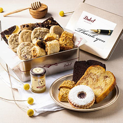 Deluxe honey pastry gift tin with assorted cookies, plate of cake slices, and gift card