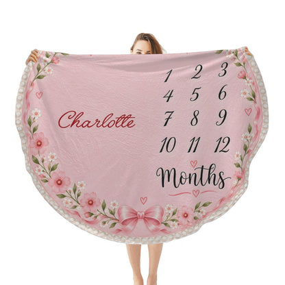 Pink round baby milestone blanket with floral border, name Charlotte and age months numbers