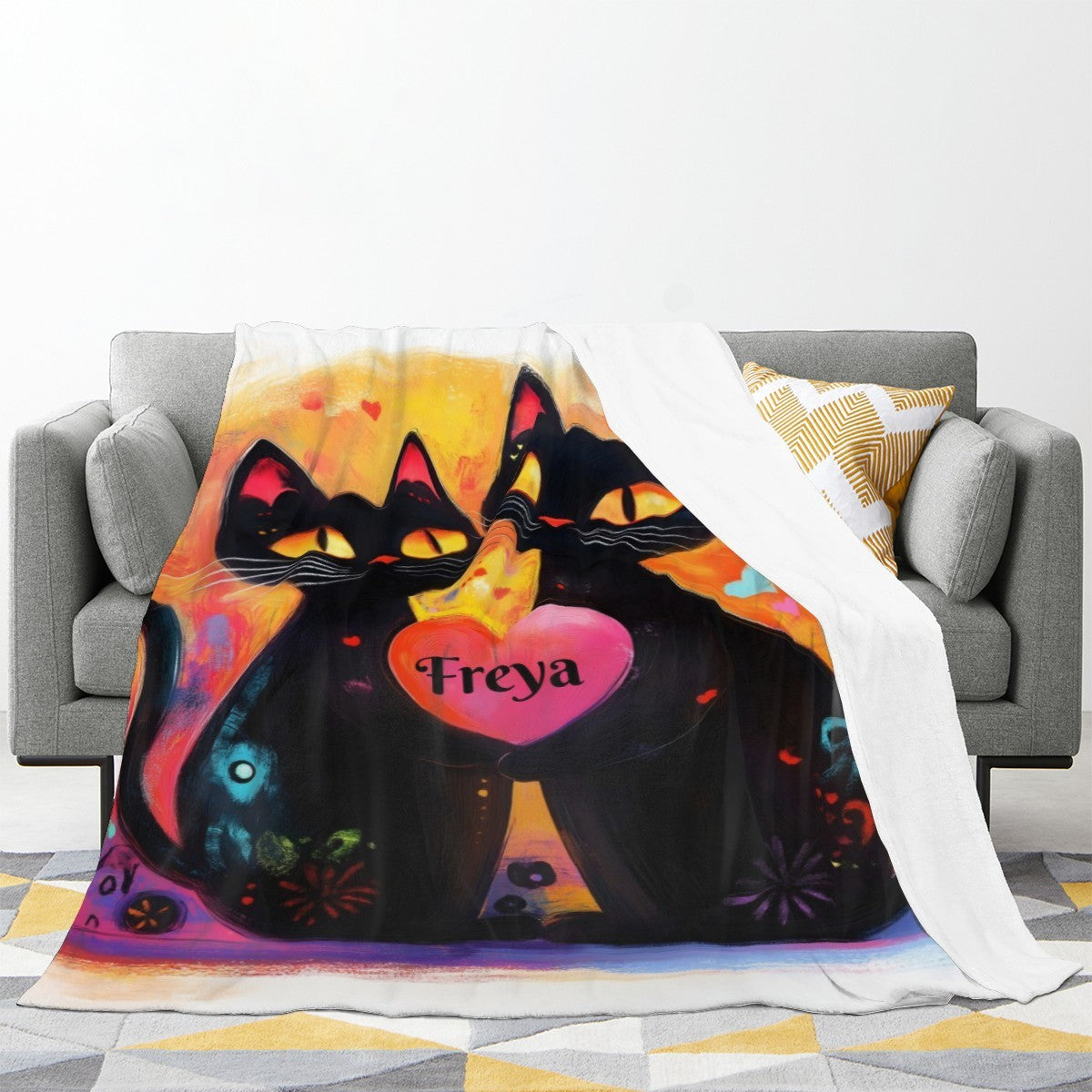 Custom cat blanket on sofa, two black cats with pink heart and name Freya