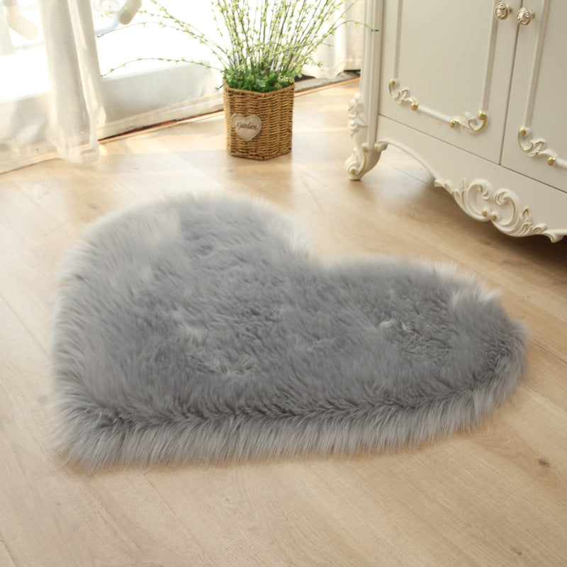 Gray heart-shaped faux fur rug with dense shaggy plush pile