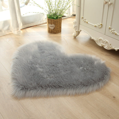Gray heart-shaped faux fur rug with dense shaggy plush pile
