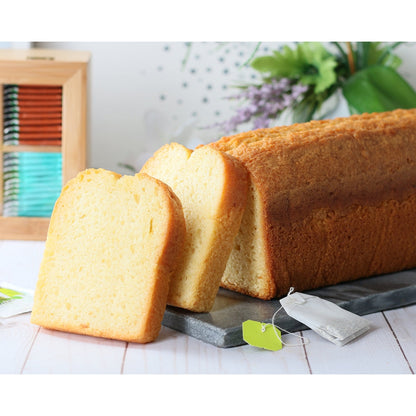 Sliced holiday cake loaf and bread pieces in gift basket packaging
