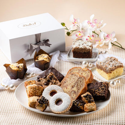 Assorted sympathy pastry gift basket with cakes, cookies, and a white ribboned gift box