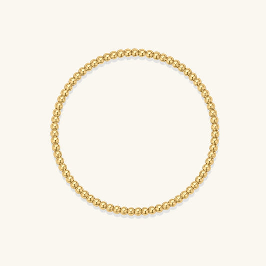 Gold bead elastic bracelet with round metallic beads, smooth flexible fit