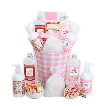 Spa gift basket with pink gingham bucket, bath bottles, bath salts, wrapped soaps, rose