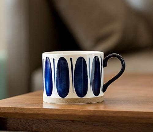 Navy oval brushstroke porcelain mug with black handle and tan base ring