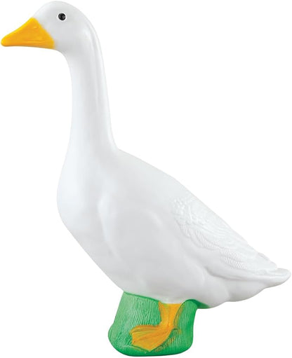 Large white goose statue with yellow beak and feet on a green base