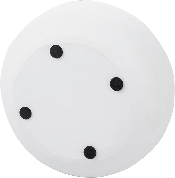 White round concrete bowl with four black dot feet
