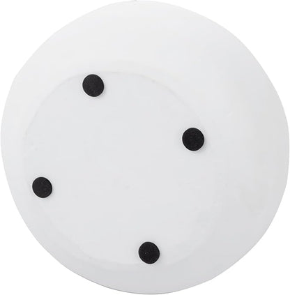 White round concrete bowl with four black dot feet