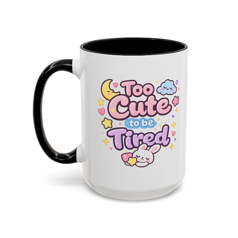 White mug with black rim and handle, kawaii bunny “Too Cute to be Tired” front graphic.