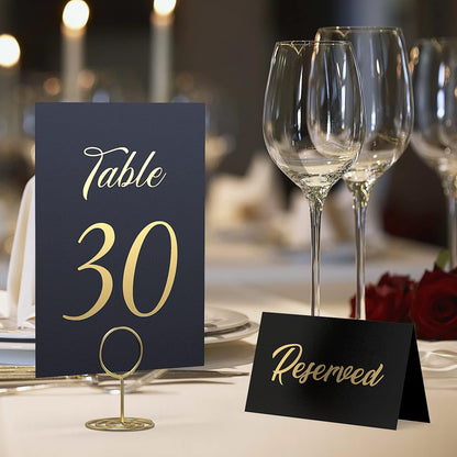 Black “Table 30” card with gold foil on a stand and a separate “Reserved” card