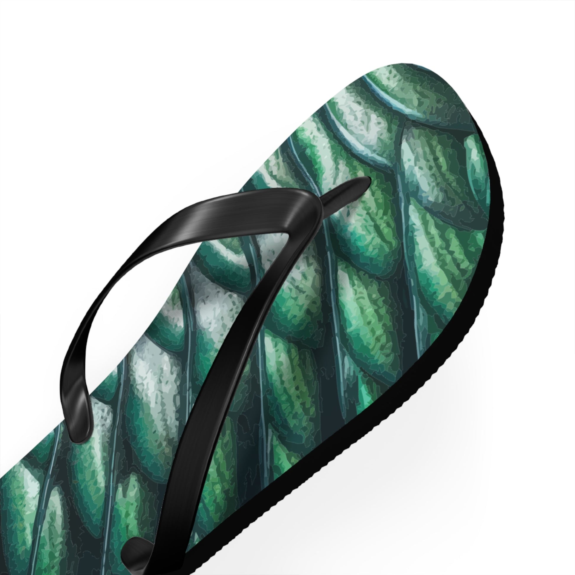 Angled view of green merman scales flip flop with black thong straps and thick sole
