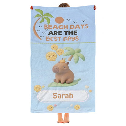 Light blue beach towel with bear, palms, lemons, 'Beach Days' text, and Saran label.