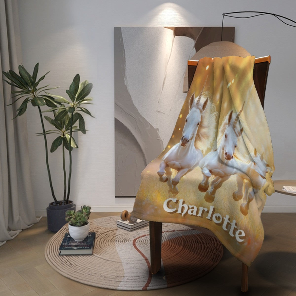 Unicorn name blanket draped on chair with three white horses and name Charlotte