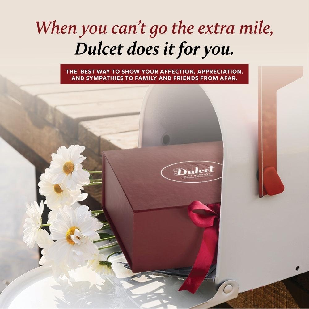 Sampler gift box with red ribbon and white candle