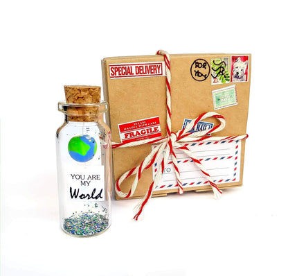 Wrapped miniature bottle keepsake with cork and “You Are My World” message in box
