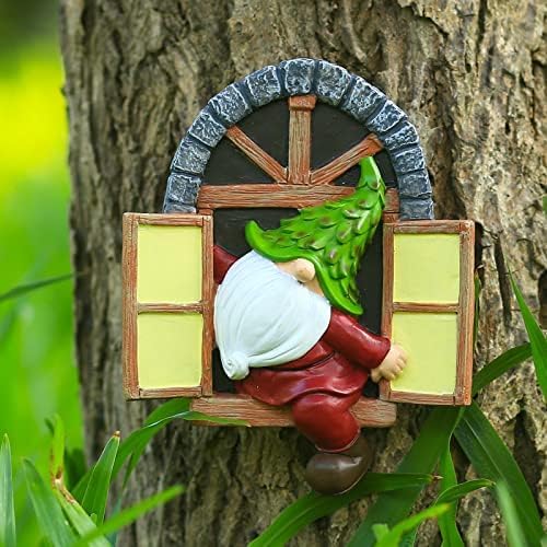 Garden gnome statue with green vine over white cap, red pants, wooden window frame