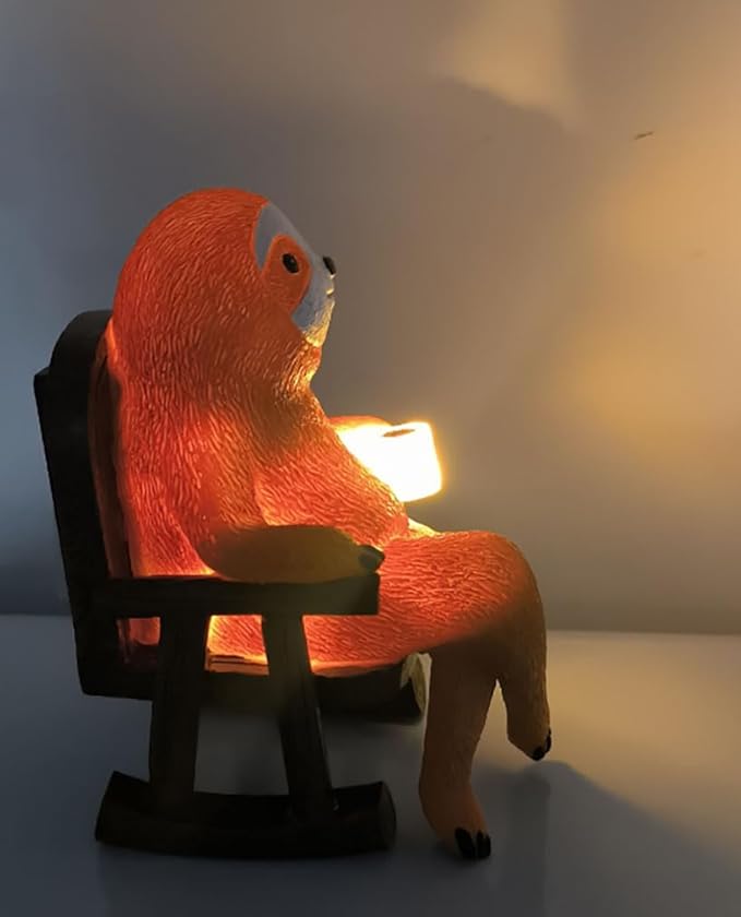 Solar light sloth figurine on dark chair, side view with warm glowing light.
