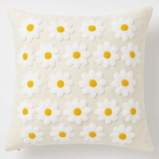 Natural cotton daisy throw pillow cover with white petals and yellow centers, textured stitch