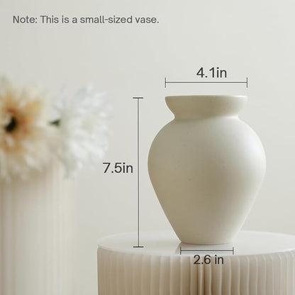 Cream ceramic milk can vase, matte speckled surface with flared top and rounded body.
