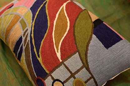 Lumbar pillow cover side view with stitched multicolor abstract forms and circle accents