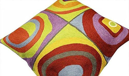 Abstract geometric pillow cover with multicolor concentric arcs on a diagonal view