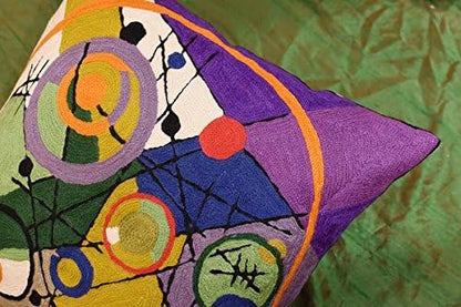 Close-up of multicolor abstract circle embroidery on a purple and orange pillow cover
