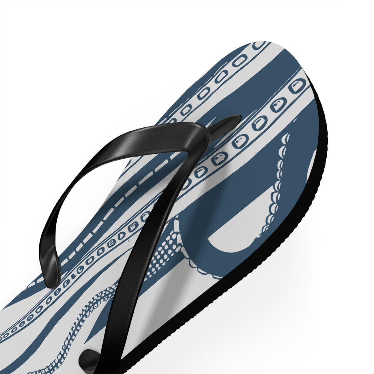 Close-up angled view of blue octopus print flip-flop with black thong strap