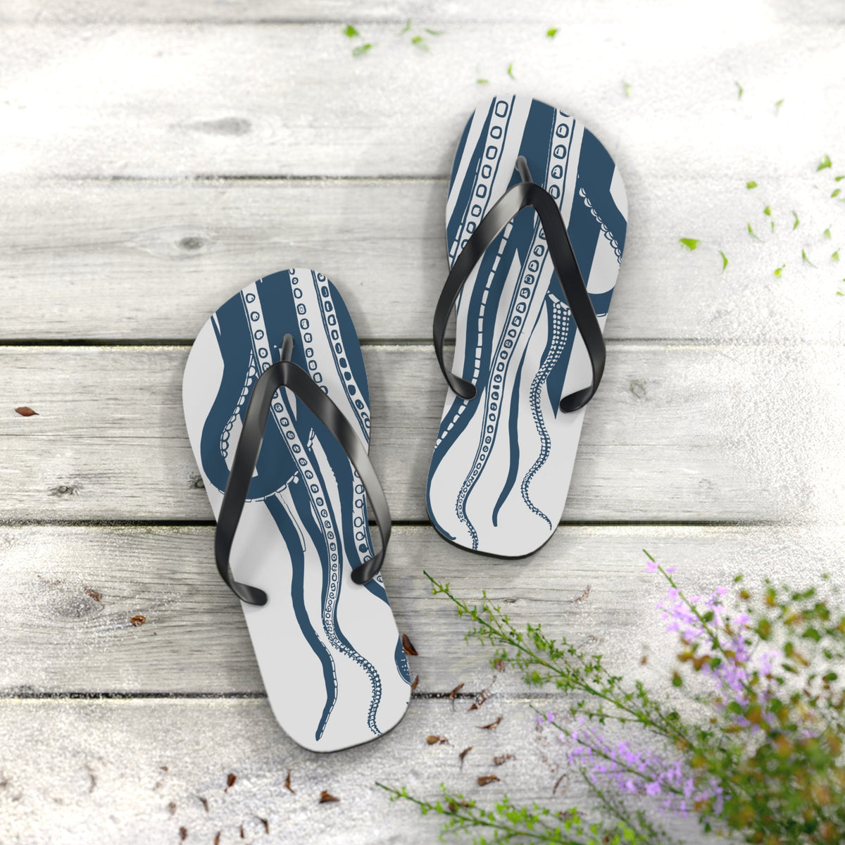 Pair of blue octopus print flip-flops with black straps and white footbeds
