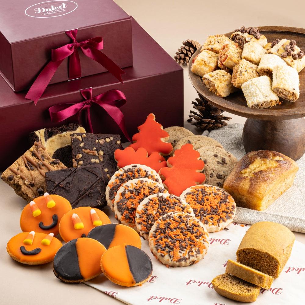 Halloween cookie assortment: orange pumpkin and black cat-shaped cookies with pastries