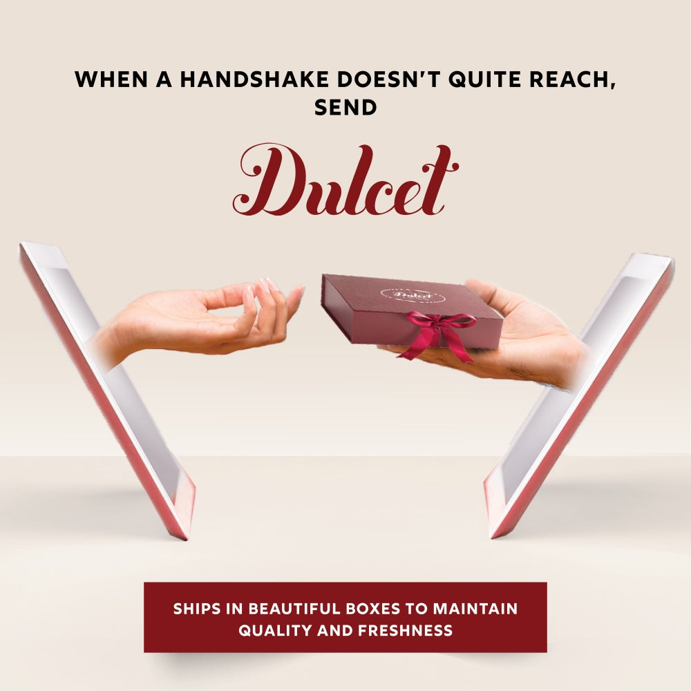 Dulcet holiday gift box with red ribbon bow held by two hands