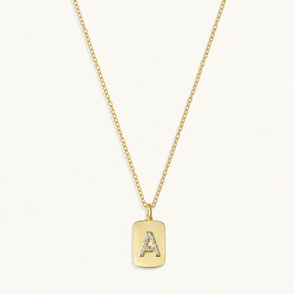 10k gold initial dog tag necklace with raised A charm and sapphire accents