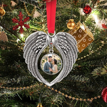 Angel wings heart photo ornament hanging on Christmas tree with red ribbon