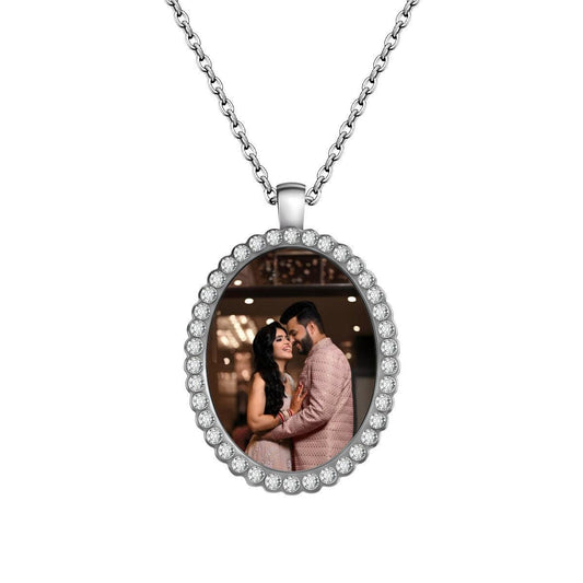 Silver oval photo pendant necklace with crystal halo and chain, featuring a couple photo