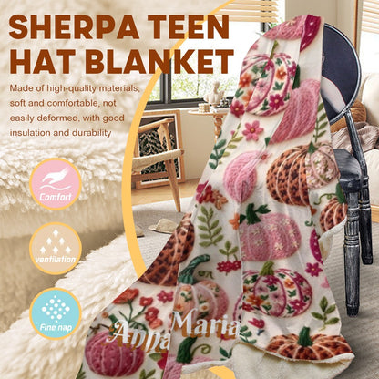 Sherpa hooded blanket with pink-and-orange pumpkin print and fleece trim.