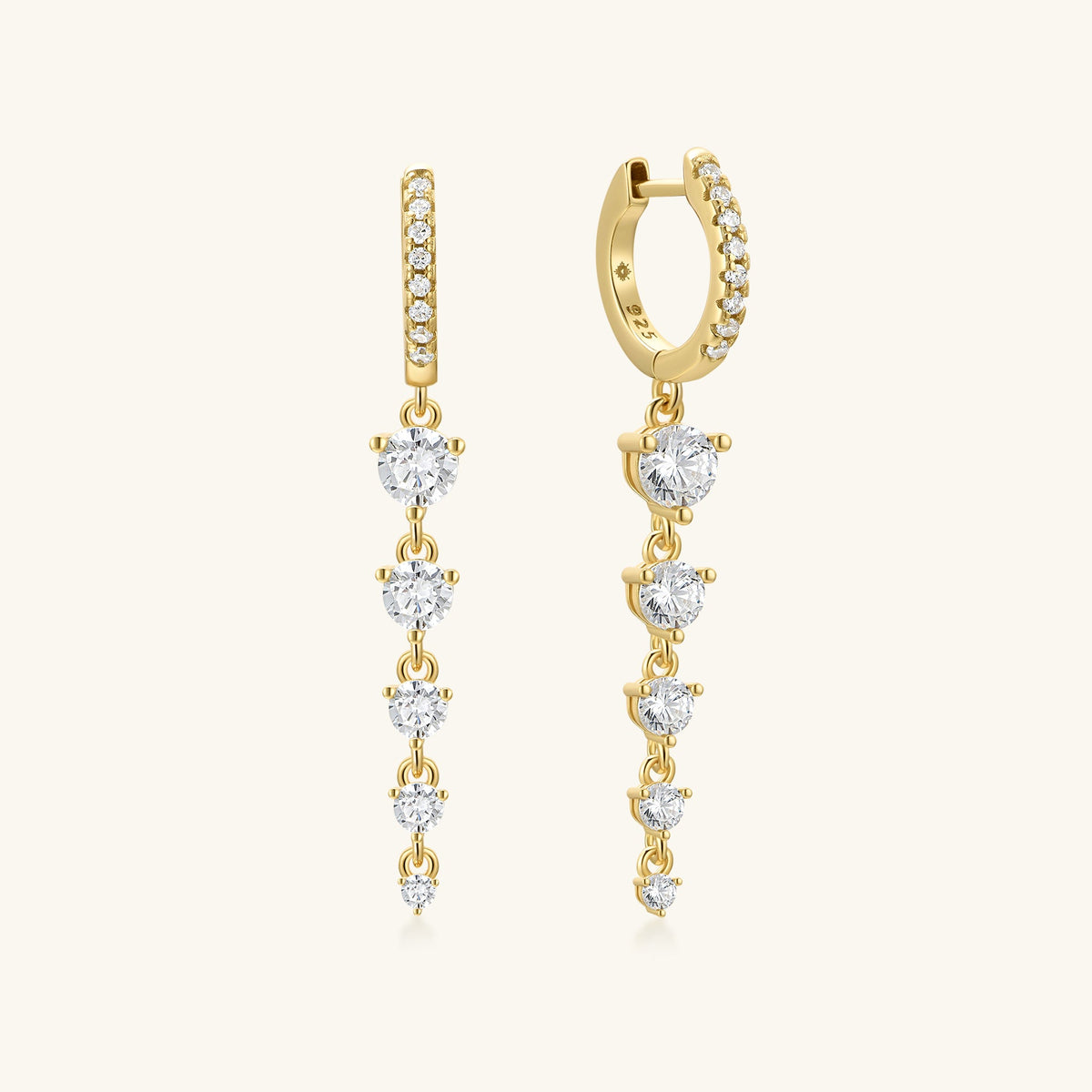 Gold hoop earrings with dangling round clear stones in a tiered drop design