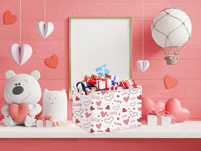 Pink Love and heart gift basket with black handles on a shelf beside decorative items