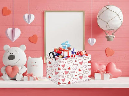 Pink Love and heart gift basket with black handles on a shelf beside decorative items