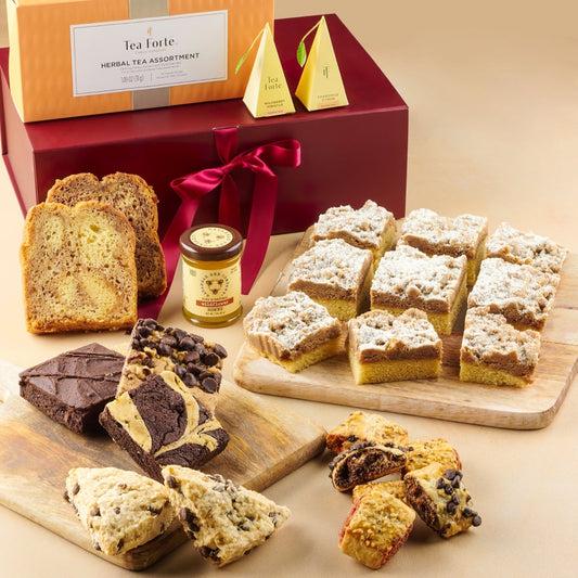 Assorted pastries and tea starter in a gift box with a red ribbon