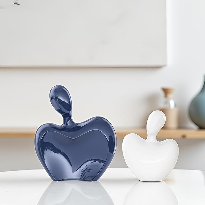 Two-piece blue and white ceramic couple figurines, glossy hugging heart shapes.