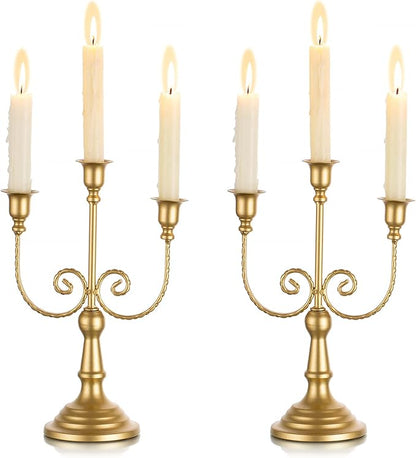 Gold three-stem metal taper candle holder set with ornate scroll arms and pedestal base