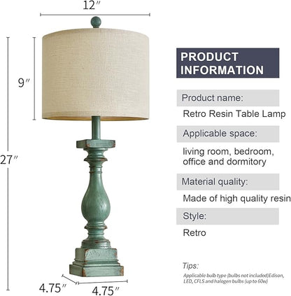 Tall view of green resin table lamp with round beige fabric shade