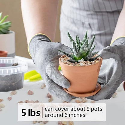 Peach-colored natural stone pebbles being placed into a small terracotta pot