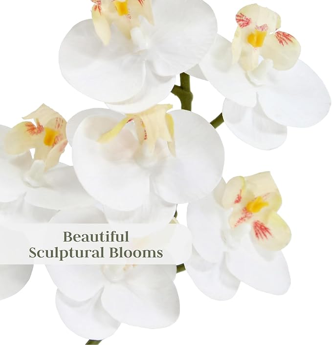 Close-up faux white orchid blossoms with soft yellow centers and green stems