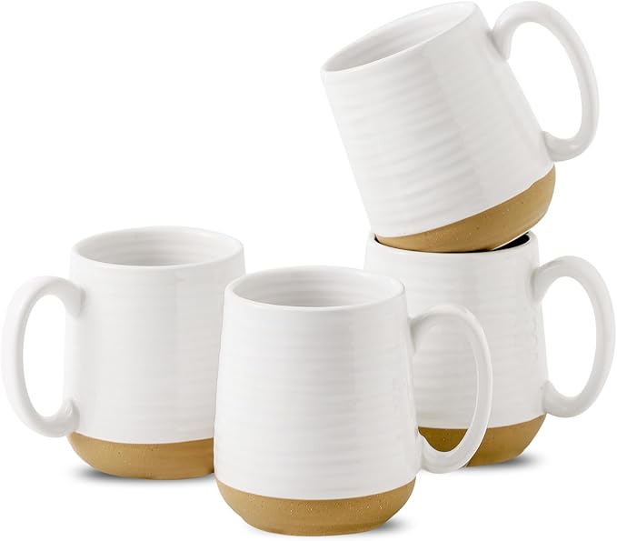 White ceramic coffee mugs with comfortable handles and a gold band around the base